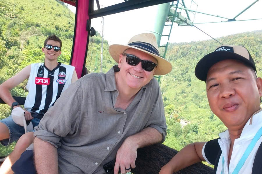 Viet Nguyen with guests aboard the Ba Na Hills cable car during a private day trip from Hoi An or Da Nang.