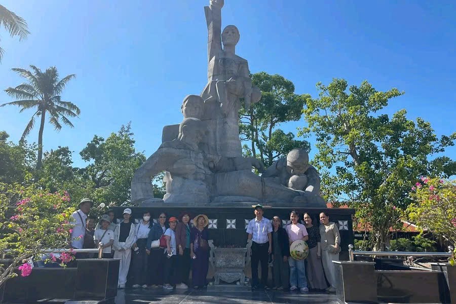 Tourists posing for a photo at the My Lai Massacre Memorial in Quang Ngai, Vietnam