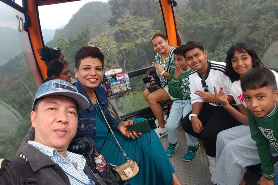 Viet Nguyen taking a selfie with guests on the cable car during a Ba Na Hills tour from Da Nang