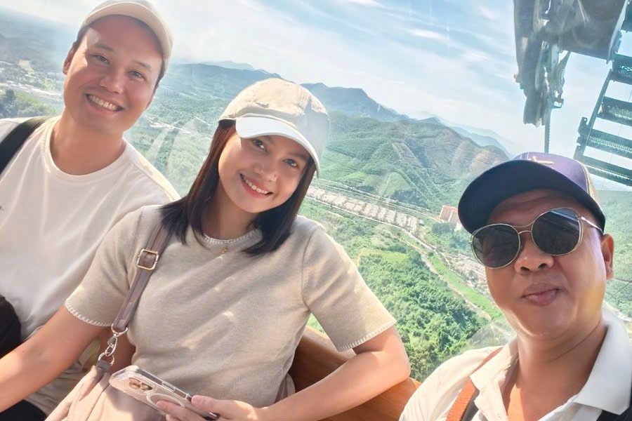 Viet Nguyen takes a selfie with guests during a cable car ride to Ba Na Hills