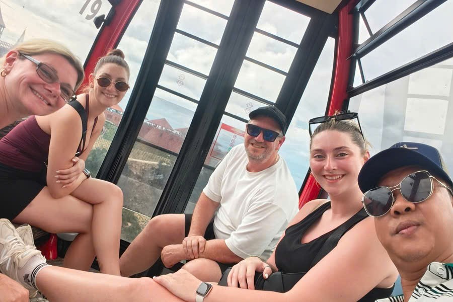 Viet Nguyen takes a selfie with guests inside the Ba Na Hills cable car