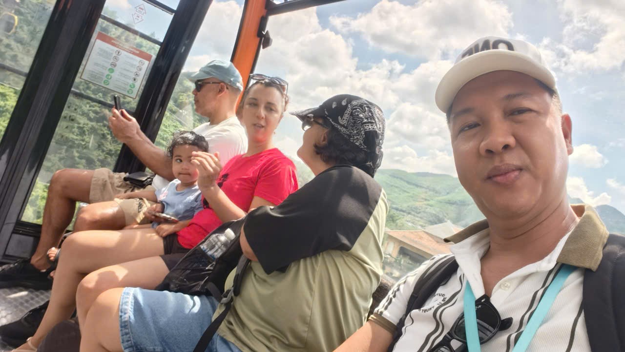 Viet Nguyen taking photos during the cable car ride on the Ba Na Hills Sunrise Tour from Da Nang.